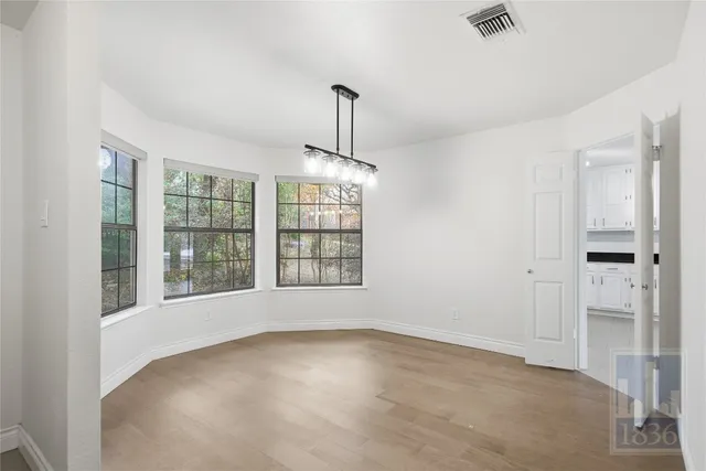 an empty room with windows and entrance