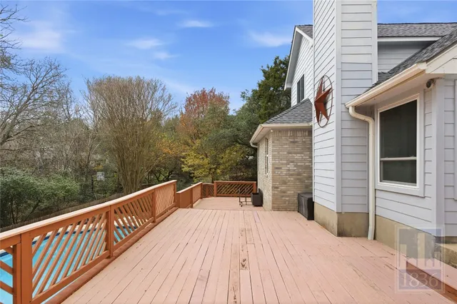 a view of a roof deck with wooden floor and fence