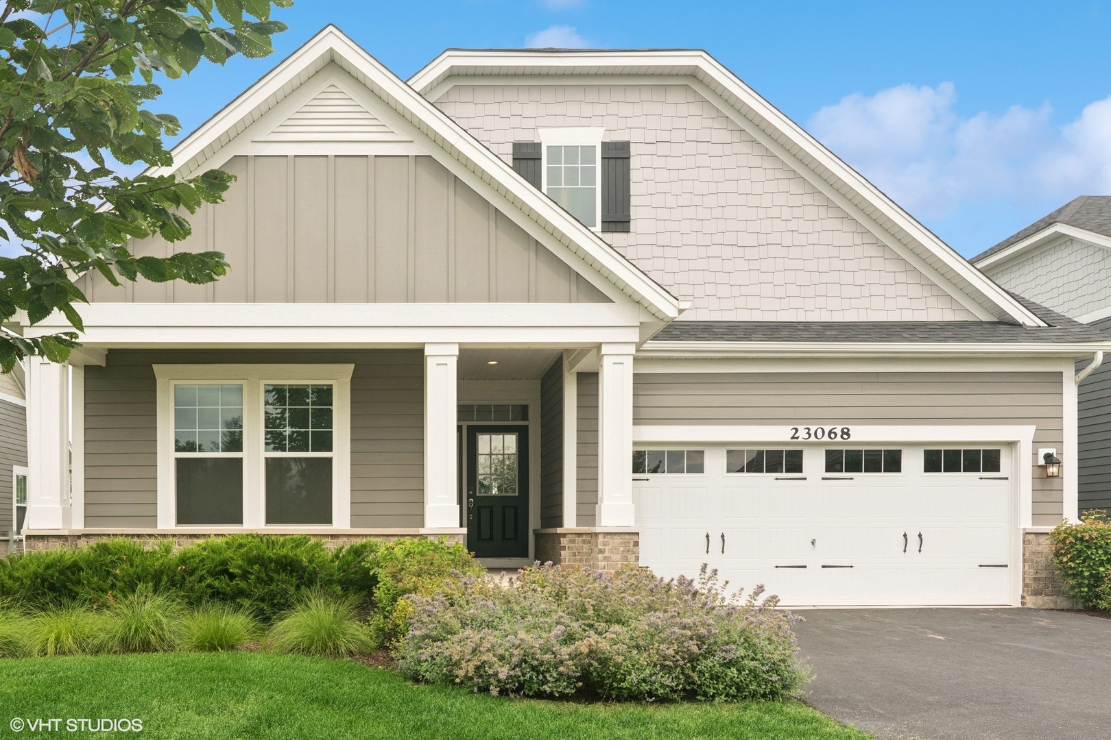 a view of white house with large windows and a yard
