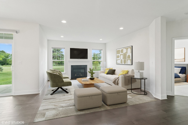 23068 Pinehurst Drive Kildeer, IL 60047 - Photo 6 of 30 a living room with furniture a fireplace and a flat screen tv