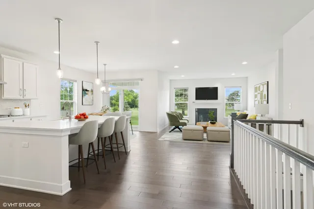 a view of a kitchen and dining room with wooden floor windows