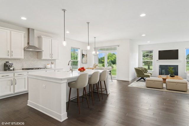 23068 Pinehurst Drive Kildeer, IL 60047 - Photo 8 of 30 a kitchen with a table chairs stove and kitchen island