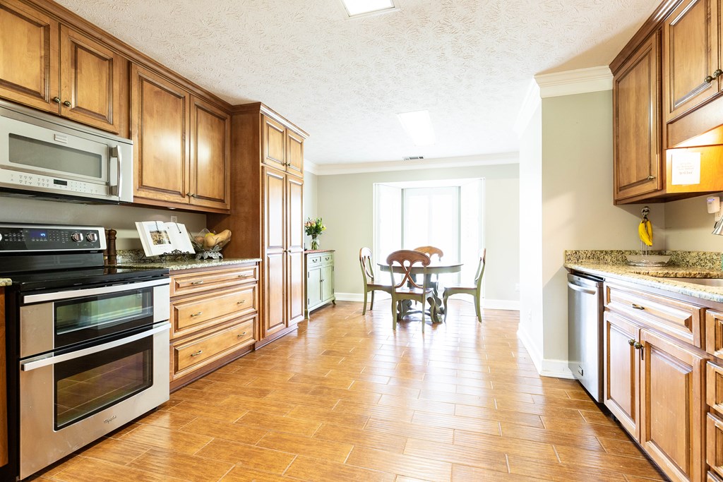 336 Clark Road Seale, AL 36875 - Photo 19 of 66 a kitchen with stainless steel appliances granite countertop a stove a sink and a refrigerator