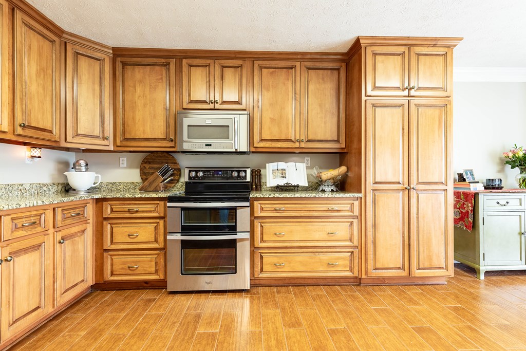 336 Clark Road Seale, AL 36875 - Photo 20 of 66 a kitchen with stainless steel appliances granite countertop a refrigerator and cabinets