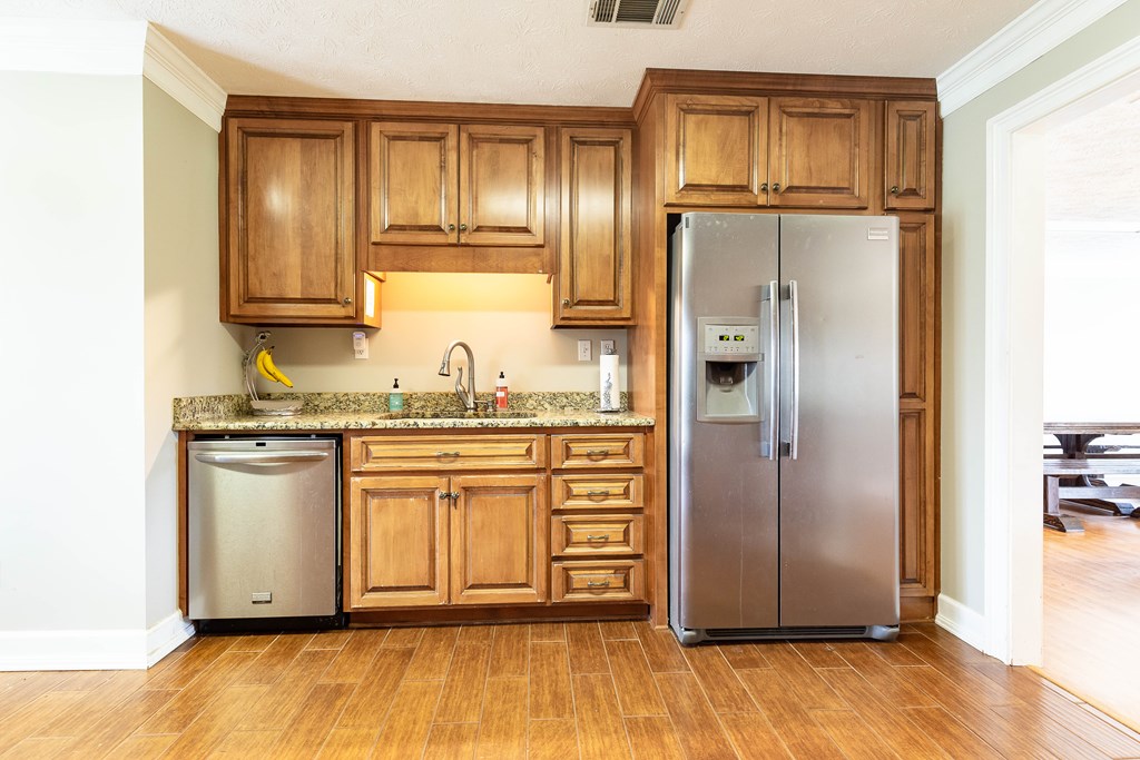 336 Clark Road Seale, AL 36875 - Photo 23 of 66 a kitchen with granite countertop stainless steel appliances a refrigerator and cabinets
