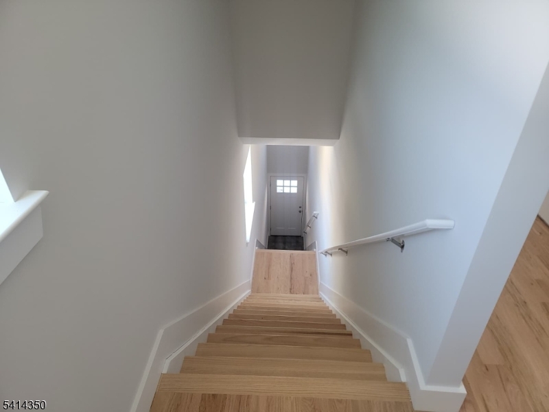118 Shephard Avenue Newark, NJ 07112 - Photo 1 of 15 a view of a hallway with wooden floor and staircase
