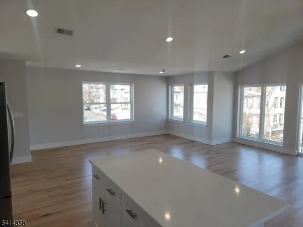 a view of kitchen with wooden floor and electronic appliances