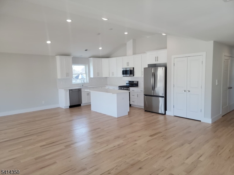 118 Shephard Avenue Newark, NJ 07112 - Photo 14 of 15 a view of kitchen with wooden floor and electronic appliances