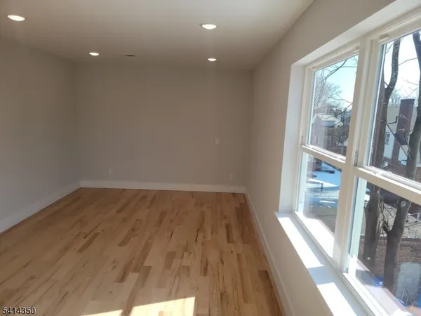 a view of a room with wooden floor and windows