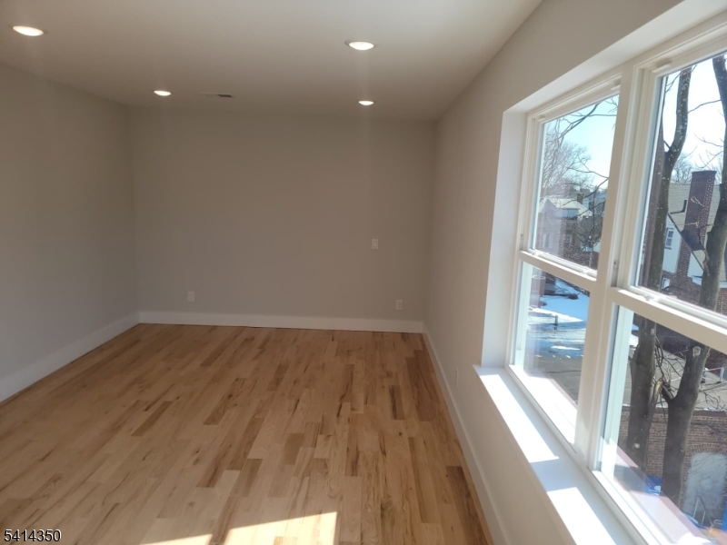 118 Shephard Avenue Newark, NJ 07112 - Photo 2 of 15 a view of a room with wooden floor and windows