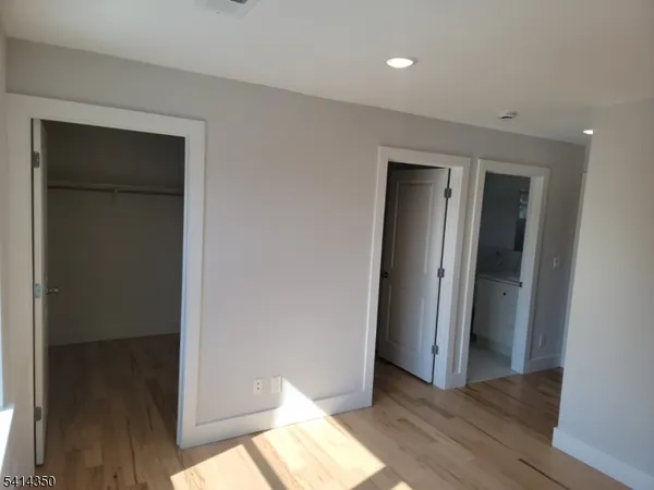 a view of hallway with wooden floor
