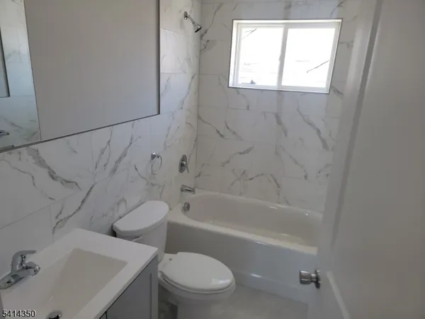 a bathroom with a sink toilet and bathtub
