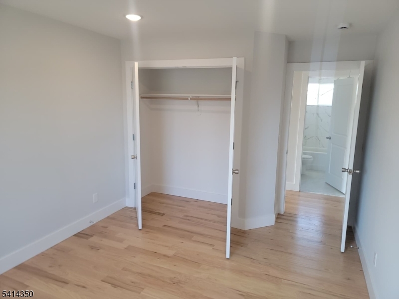 118 Shephard Avenue Newark, NJ 07112 - Photo 10 of 15 a view of an empty room with wooden floor