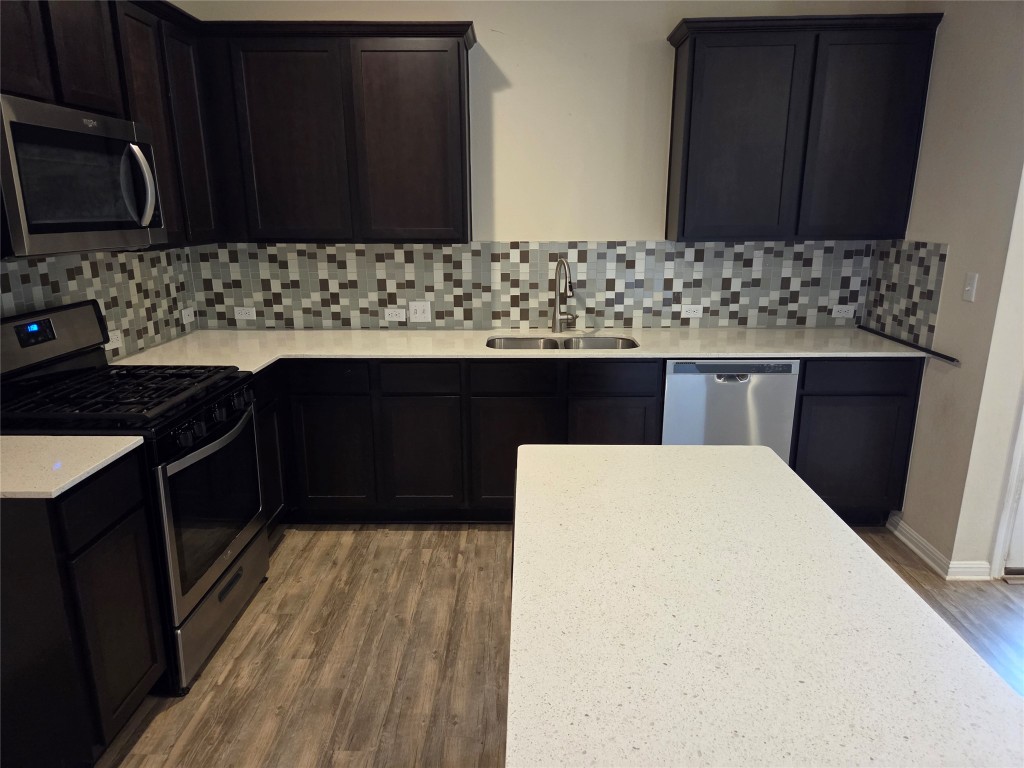 a kitchen with a sink and wooden cabinets
