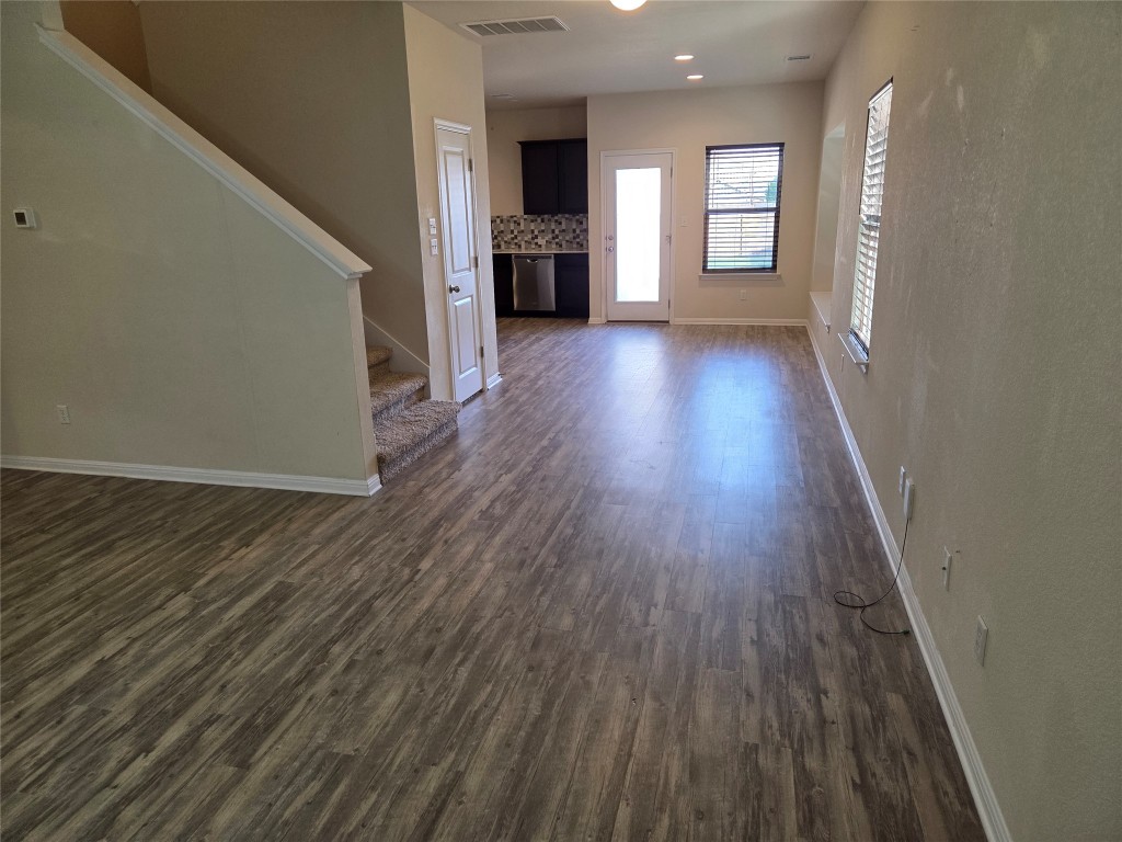 8136 Daisy Cutter Crossing Georgetown, TX 78626 - Photo 11 of 27 wooden floor in an empty room with a window