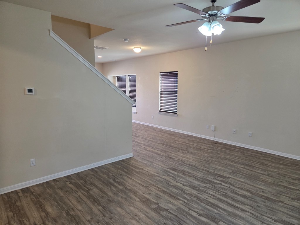 8136 Daisy Cutter Crossing Georgetown, TX 78626 - Photo 13 of 27 wooden floor in an empty room with a window