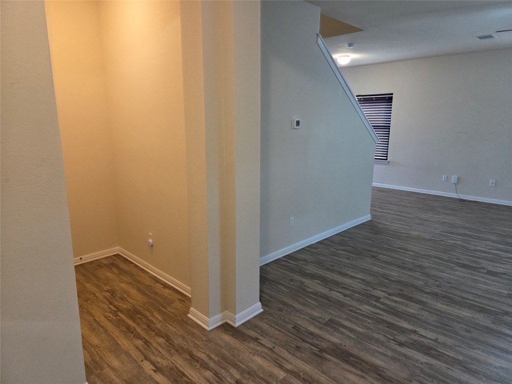 8136 Daisy Cutter Crossing Georgetown, TX 78626 - Photo 16 of 27 a view of an empty room with wooden floor