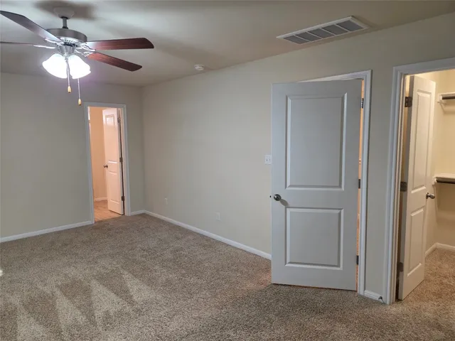 a bathroom with a glass shower door