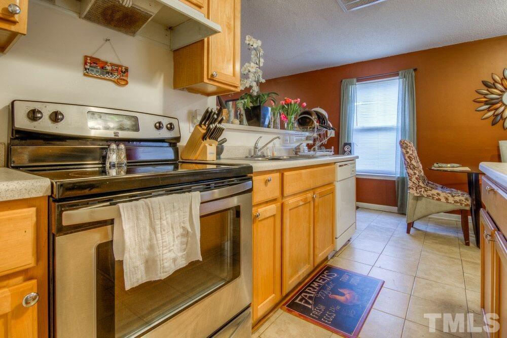 3609 Croydon Mill Way Raleigh, NC 27616 - Photo 6 of 15 a kitchen with stainless steel appliances granite countertop a sink and cabinets