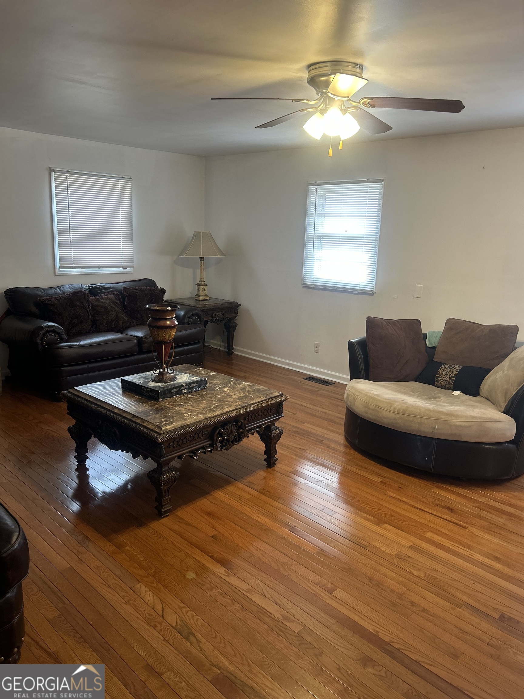 1406 Canterbury Road Griffin, GA 30223 - Photo 16 of 26 a living room with furniture a window and a chandelier