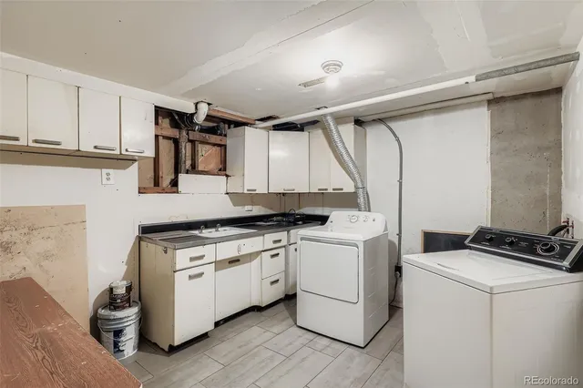 a view of a kitchen with sink and cabinets