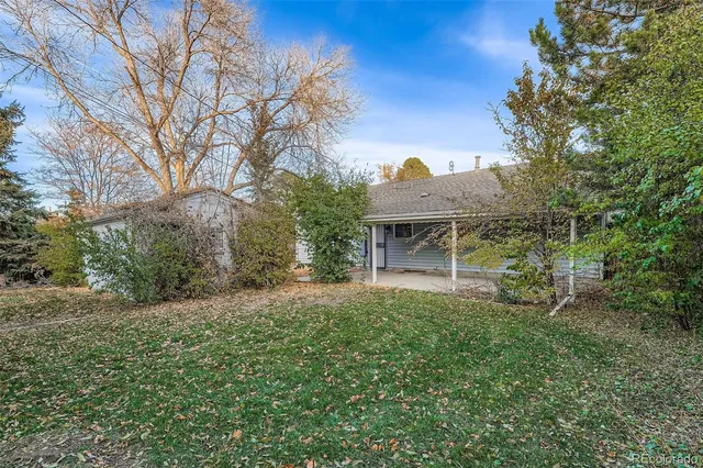 a view of a house with a yard and sitting area