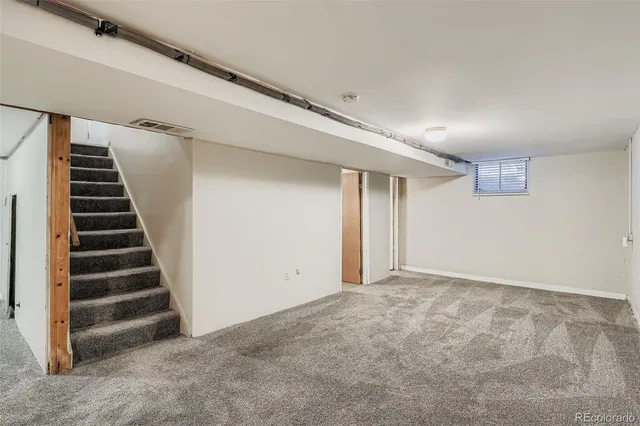 a view of an empty room with stairs