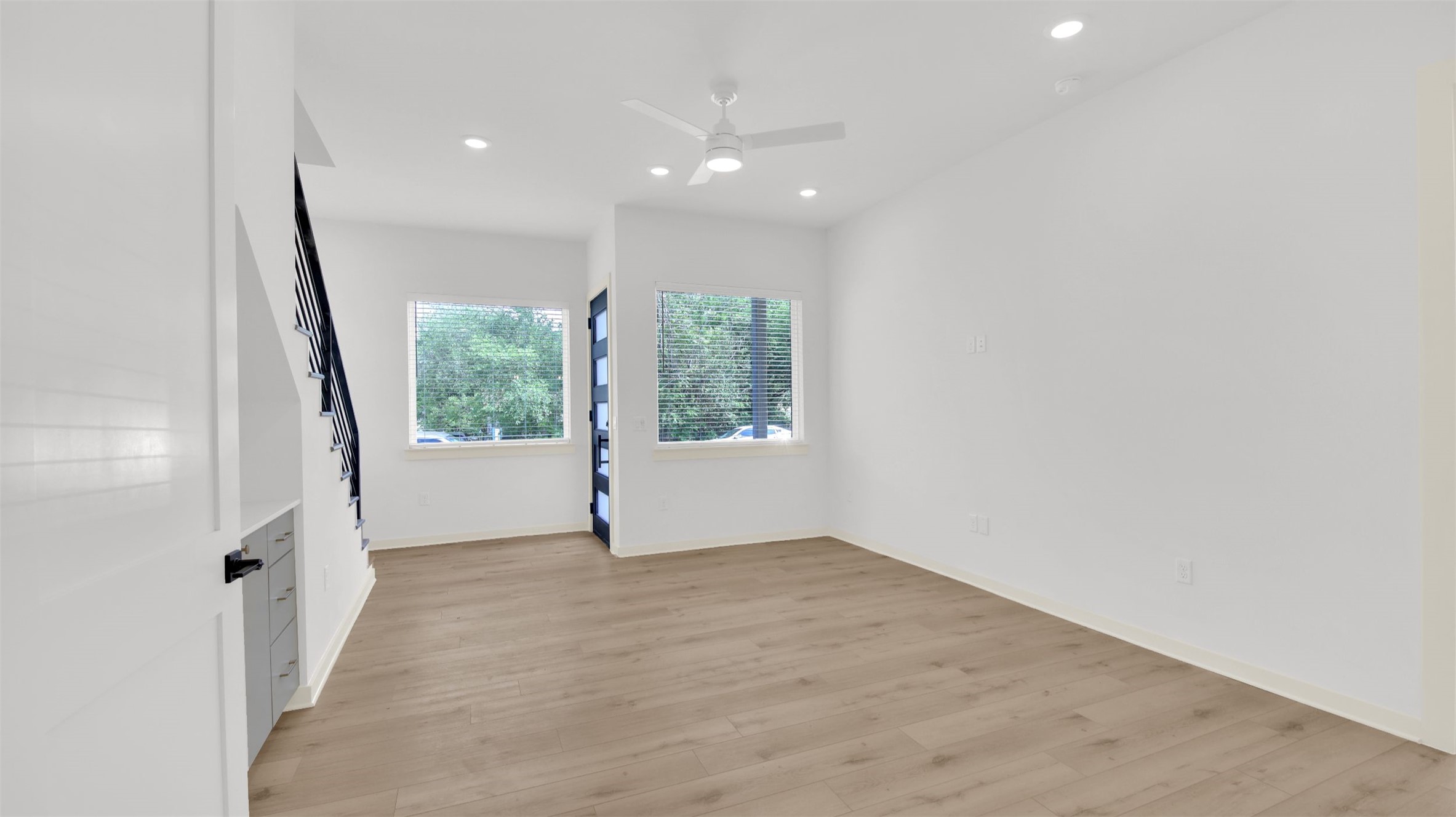 7208 Providence Avenue, Unit 1 Austin, TX 78752 - Photo 6 of 26 The interior features light-toned flooring, recessed lighting, and a ceiling fan