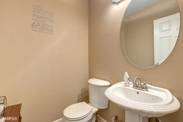 a white toilet sitting next to a bathroom sink