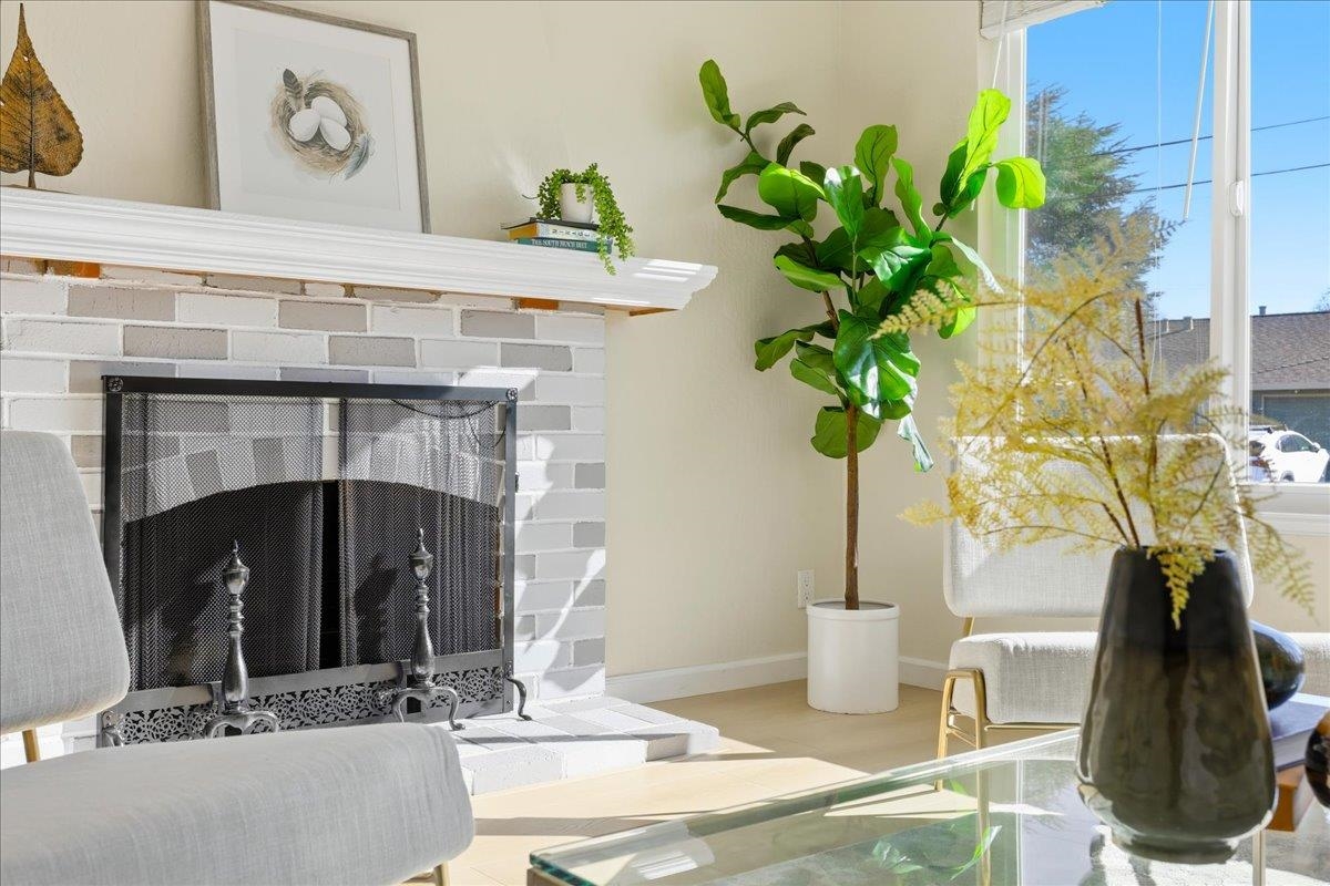 7109 Elba Way Dublin, CA 94568 - Photo 11 of 60 a vase of flowers sitting on a table with a fireplace