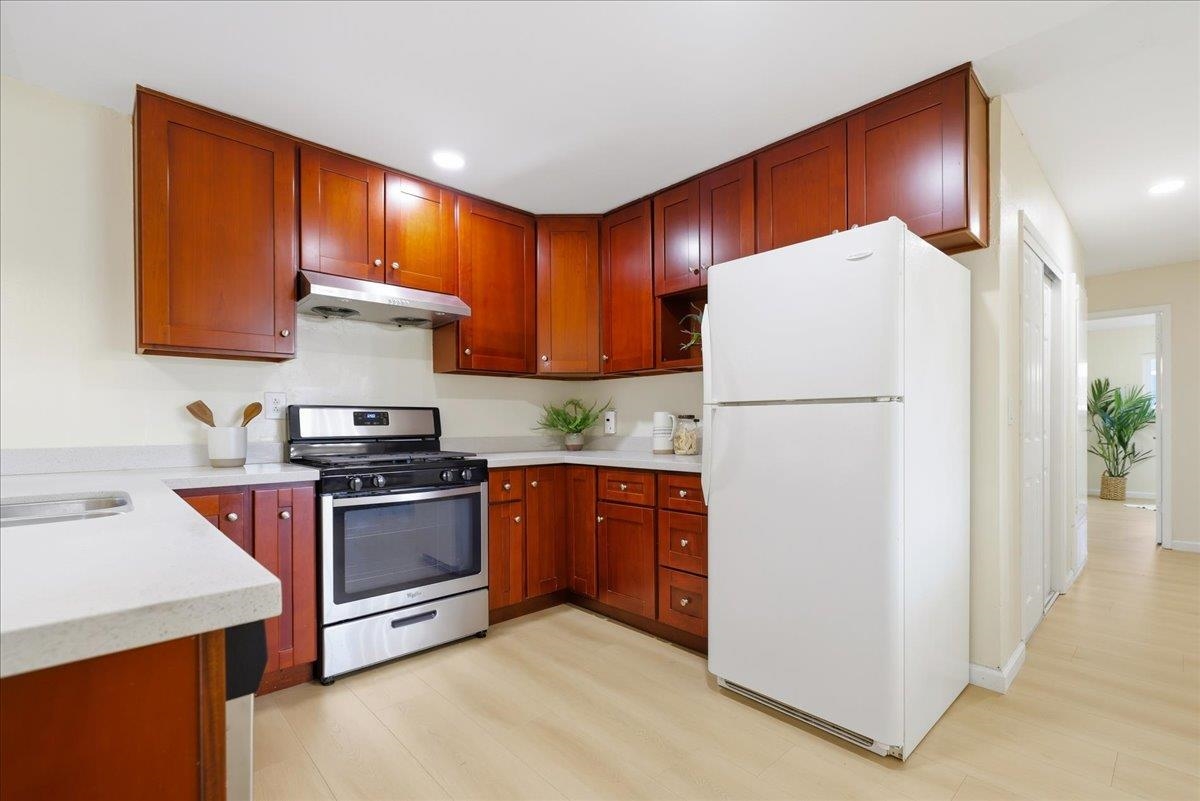 7109 Elba Way Dublin, CA 94568 - Photo 21 of 60 a kitchen with stainless steel appliances granite countertop a refrigerator stove a sink and dishwasher