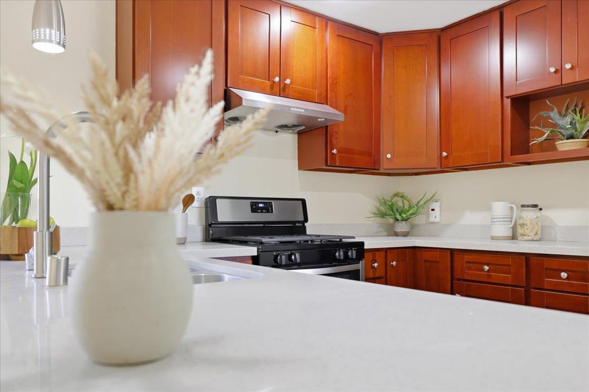 7109 Elba Way Dublin, CA 94568 - Photo 23 of 60 a kitchen with stainless steel appliances granite countertop a stove a sink and a microwave