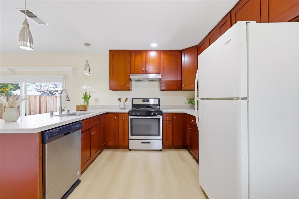 7109 Elba Way Dublin, CA 94568 - Photo 25 of 60 a kitchen with stainless steel appliances granite countertop a refrigerator a sink dishwasher a stove and a refrigerator