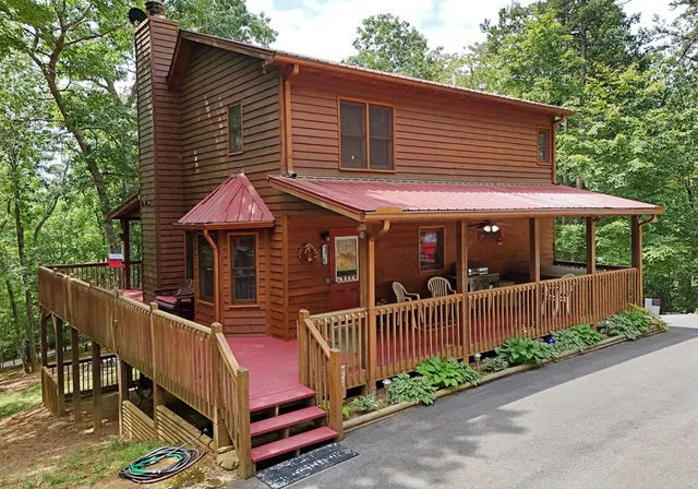 a view of a chairs and table on the wooden roof deck