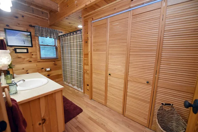 a large bed sitting in a bedroom next to a window