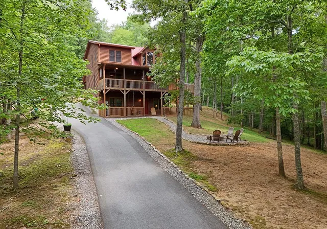a view of a house with backyard and sitting area