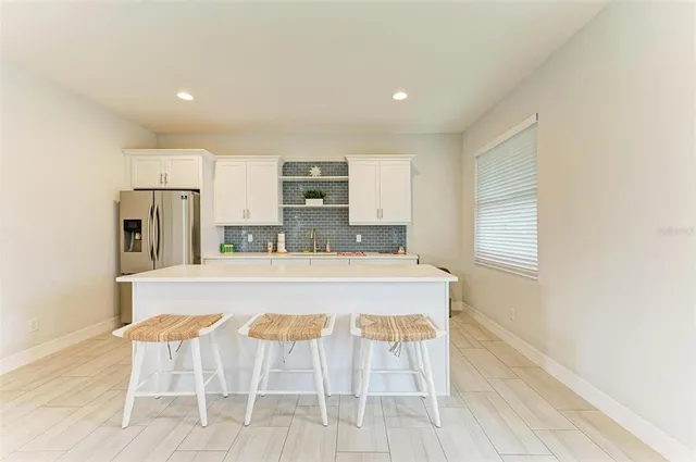 a large kitchen with a table and chairs