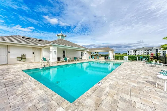 a view of swimming pool with a garden and trees