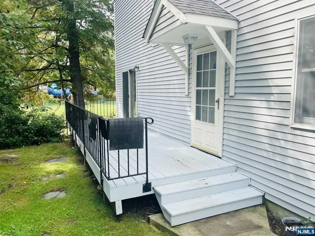 a view of a house with backyard and deck
