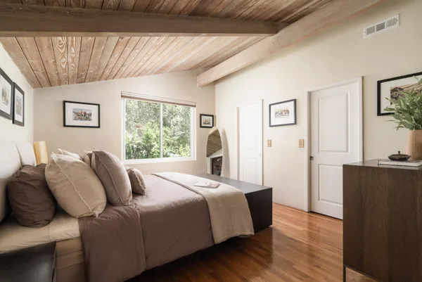a bedroom with a bed and a window