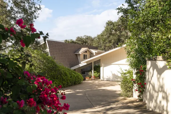 a front view of a house with a yard and a garage