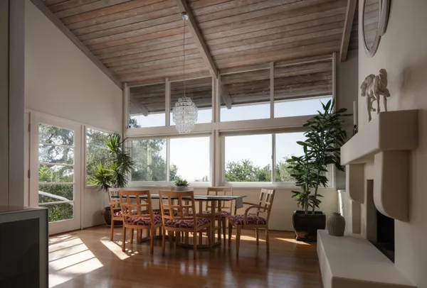 a dining room with furniture window and wooden floor
