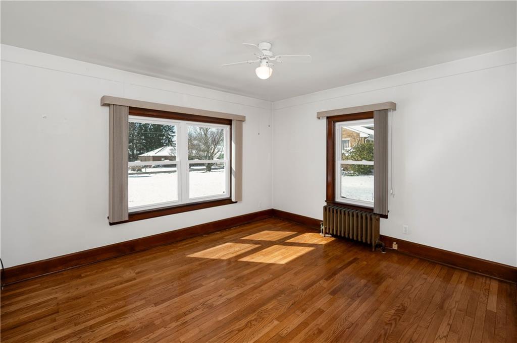 125 Merritt Drive Butler, PA 16001 - Photo 14 of 38 a view of an empty room with window and wooden floor