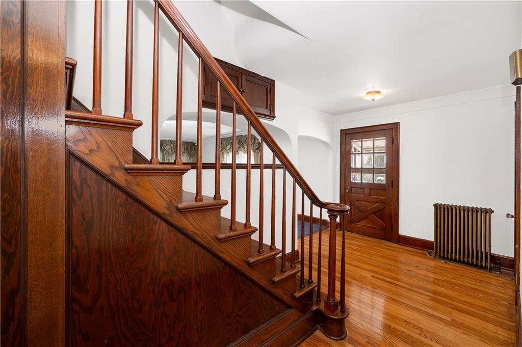 125 Merritt Drive Butler, PA 16001 - Photo 3 of 38 a view of staircase with lots of frames on wall and wooden floor