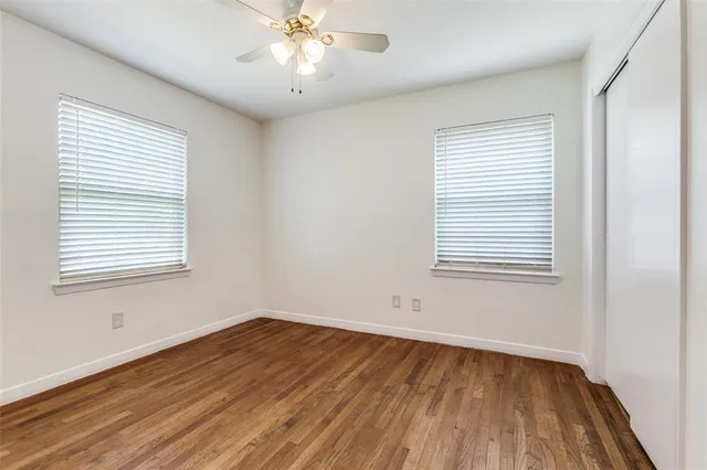 a view of a room with wooden floor and a window