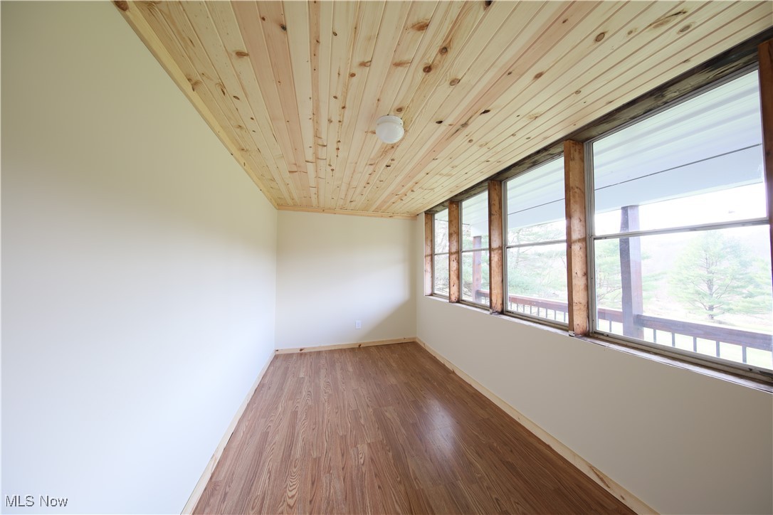 406 Avalon Road Southwest Dellroy, OH 44620 - Photo 18 of 36 Spare room featuring hardwood / wood-style flooring and wooden ceiling