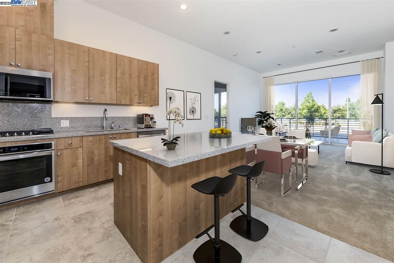 45128 Warm Springs Boulevard, Unit 105 Fremont, CA 94539 - Photo 2 of 11 a kitchen with a sink and chairs