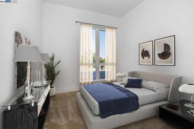 a bedroom with a large bed and a window