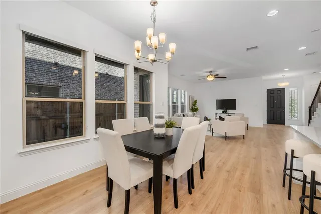 a large white kitchen with lots of counter space a sink and appliances