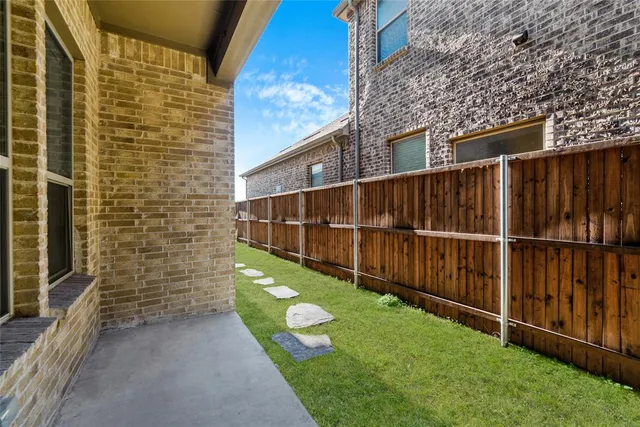 a view of a backyard with wooden fence
